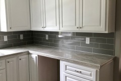 grey-subway-tile-backsplash-from-counter-to-cabinets-flush-in-kitchen