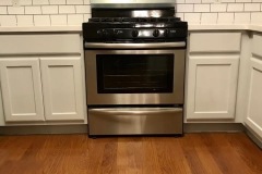 white-subway-tile-installation-behind-appliances-in-kitchen
