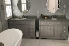 Dual-Bathroom-Sinks-with-Large-Tile-Floor-and-Freestanding-Bathtub-scaled