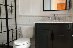 Retro-Art-Bathroom-Tile-replacement-of-floors-and-walls.-Corner-shower-enclosure-replaced.-Complete-bathroom-remodel-.-with-White-Octagons-and-Black-Square-Dots-scaled