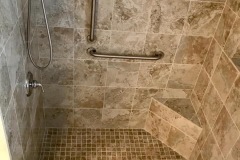 accessible-shower-with-low-step-seat-and-handrails